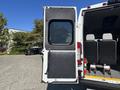 A 2020 RAM ProMaster 3500 van with an open rear door revealing a spacious interior designed for cargo or passenger transport