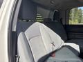 Interior of a 2013 RAM 5500 with a gray bench seat featuring seat belts and headrests