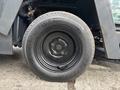A black tire mounted on a 2019 Madvac LS175 featuring a deep tread pattern and a central hub with a circular design