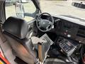 Interior view of a 2018 Chevrolet Express showcasing the driver's seat steering wheel and dashboard controls
