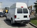 A white 2008 Ford Econoline van with a high top roof viewed from the rear, showing the rear doors and no visible license plate