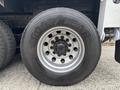 Close-up of a Goodyear tire mounted on a 2013 Freightliner 114SD featuring visible wheel rim and multiple lug bolts