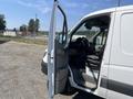 A 2016 Mercedes-Benz Sprinter van with the driver's side door open showcasing the interior and driver's seat