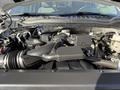 The engine compartment of a 2021 Ford F-250 SD featuring the engine assembly and components clearly visible