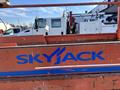A close-up of the Skyjack logo on a 2010 Skyjack SJ lift with a vibrant orange background