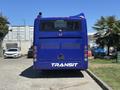 A blue 2018 Grande West Vicinity bus with the word TRANSIT on its rear and a visible exhaust pipe