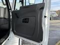 The image shows the interior driver's side door of a 2012 International DuraStar 4300 featuring a black door panel and handle