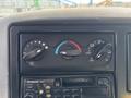 Dashboard controls of a 2006 International 4300 featuring knobs for fan speed and temperature adjustment alongside a Panasonic radio unit