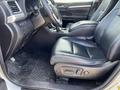 Interior of a 2018 Toyota Highlander showing black leather front seats and center console with gear shift and controls in the foreground