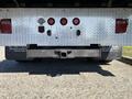 Rear view of a 2020 Peterbilt 330 showing its silver bumper and taillights with two red and one clear light
