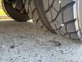 Close-up of a well-worn tire from a 2005 Freightliner M2 106 showcasing detailed tread patterns and rubber texture