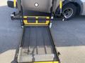 A yellow and black loading ramp with a mesh surface designed for a vehicle, featuring a sturdy frame and handles for easy operation