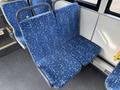A blue patterned double bus seat with a metal frame located in the interior of a 2016 Grande West Vicinity bus