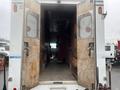 Interior view of a 2012 Workhorse W62 truck showing open rear doors and wooden paneling inside