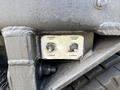 A control panel featuring two buttons labeled Hopper Lift and Hopper Dump along with a toggle switch marked Lower on a textured metal surface