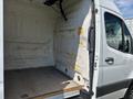 A 2019 Mercedes-Benz Sprinter with an empty cargo area featuring a wooden floor and unpainted walls showing insulation and wear