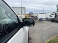 A 2016 GMC Sierra 1500 parked with its side mirror visible in the foreground