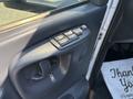 Close-up of the door control panel of a 2005 GMC C7500 Topkick featuring window and lock buttons