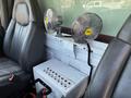 Interior view of a 2007 GMC C4500 TopKick featuring two metal fans mounted on a console with a control panel below them