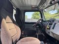 Interior view of a 2008 Peterbilt 340 showing two seats and a dashboard with various controls and a steering wheel