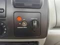 Dashboard of a 2006 Ford F-450 showing controls for passenger airbag and power point with a switch and indicator lights