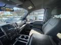 Interior view of a 2015 Ford F-150 showing the driver's seat dashboard and console with controls and storage compartments