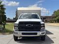 A 2020 Chevrolet Silverado with a white exterior and a black front grille facing the viewer