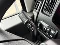 A close-up of a vehicle's multifunction lever on the steering column featuring controls for wipers headlights and turn signals