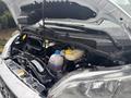The image shows the engine compartment of a 2023 RAM Promaster 3500 with various components including hoses and a coolant reservoir