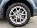 A silver alloy wheel with a five-spoke design mounted on a black tire labeled as studless