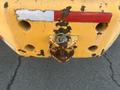 Close-up of the rear end of a yellow 2013 JCB 510-56 Loadall showing rust and wear with a hitch and chain visible