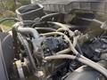 Close-up view of the engine components of a 2011 International 4300 featuring various hoses and an electrical connector