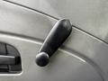 A black window crank handle on the door of a 2011 International 4300