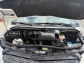 A 2016 Mercedes-Benz Sprinter with its hood raised revealing the engine compartment and various mechanical components inside