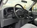 Interior of a 2008 Ford Econoline showing the steering wheel dashboard and cup holders