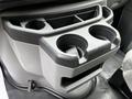 A cup holder section of a 2018 Ford Econoline featuring two circular openings and a small compartment below for storage