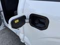 Close-up of the fuel door on a 2021 Ford F-150 showing the fuel filler neck and instructions for fueling