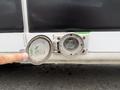 A close-up of an electrical outlet on a 2020 RAM Promaster showing a circular socket with a protective cover and identifying numbers inside