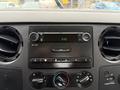 Dashboard of a 2008 Ford F-250 SD featuring a radio and climate control dials