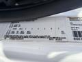A close-up of a label on a 2013 International 7500 truck showing specifications including axle weights and vehicle identification information