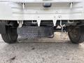 A 2010 Daihatsu Hijet with a visible spare tire mounted underneath the rear section of the vehicle