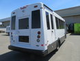 A white 2020 Chevrolet Express van with a low-profile roof and large windows designed for accessibility with a wheelchair access door on the rear