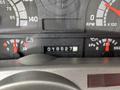 Dashboard of a 2002 GMC C7500 featuring speedometer, tachometer, fuel gauge, oil pressure gauge, and odometer reading 18527