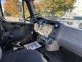 Interior view of a 2005 Freightliner M2 106 truck showing the driver's seat dashboard steering wheel and various control panels