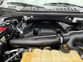 Close-up view of the engine of a 2018 Ford F-150 showcasing the engine block air intake system and various components including hoses and electrical connections