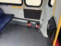 Interior view of a 2020 Chevrolet Express showing two foot pedals mounted to the floor with a blue seat nearby