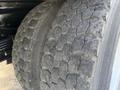 Close-up of two rugged tires on a 2018 Ford F-750 showcasing deep treads and worn surfaces