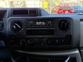 Interior dashboard of a 2021 Ford Econoline with radio controls air conditioning knobs and a digital display
