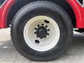 A close-up of a wheel from a 2012 International 7300 Workstar featuring a white rim and a large black tire with the brand name Goodyear RSD visible on the tread