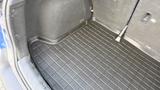Interior view of the rear cargo space of a 2019 Nissan Kicks featuring a textured black mat with raised patterns